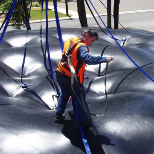 Inflatable overhead protection system deployment in industrial environment