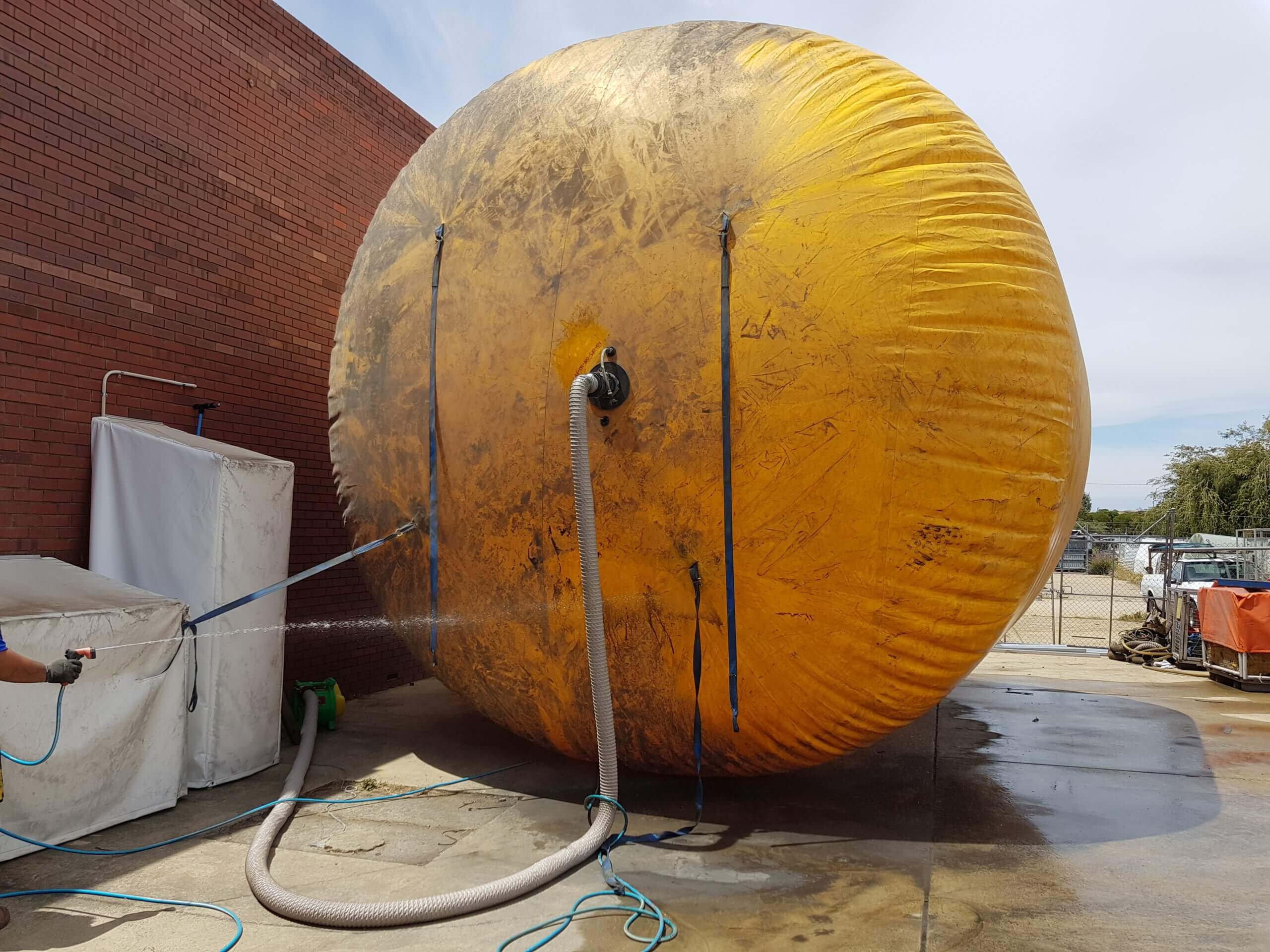 Industrial inflatable being washed before inspection and repair assessment.