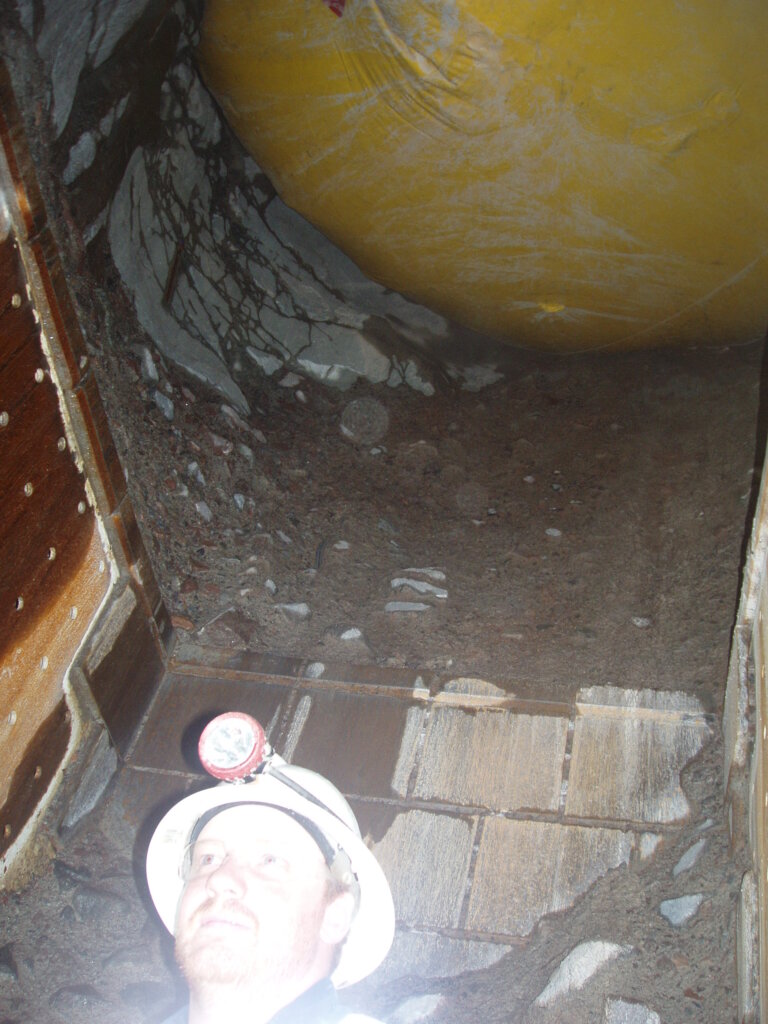 Inflatable overhead protection system inside an underground mine ore pass.